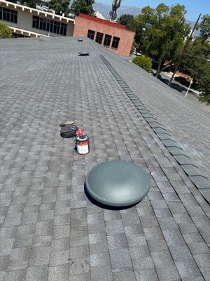 Finished GAF Timberline HDZ R/S+ field on a Mayfield School slope, looking toward campus buildings